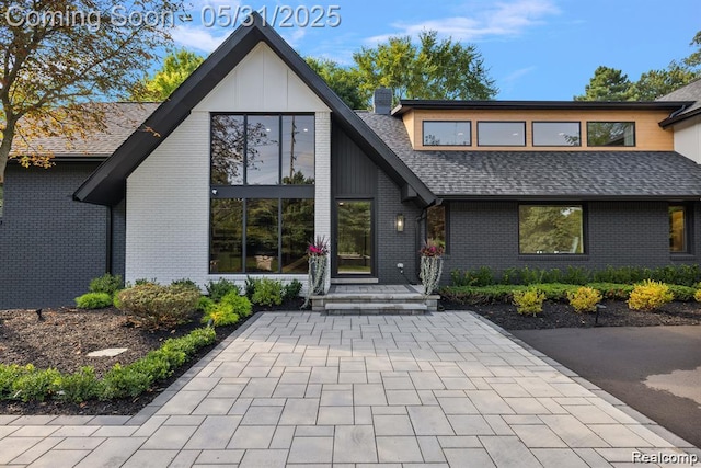 1367 W Long Lake Rd, Bloomfield Hills, MI 48302 - view of front of property with a chimney, roof with shingles, and brick siding