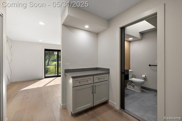 1367 W Long Lake Rd, Bloomfield Hills, MI 48302 - bathroom with toilet, wood finished floors, baseboards, and recessed lighting
