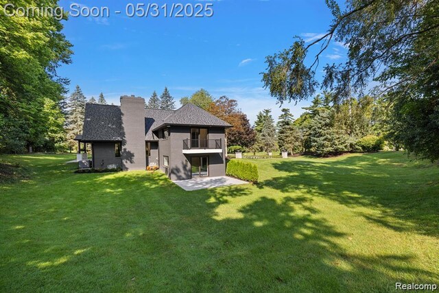 1367 W Long Lake Rd, Bloomfield Hills, MI 48302 - back of house featuring a balcony, a lawn, a chimney, and a patio area