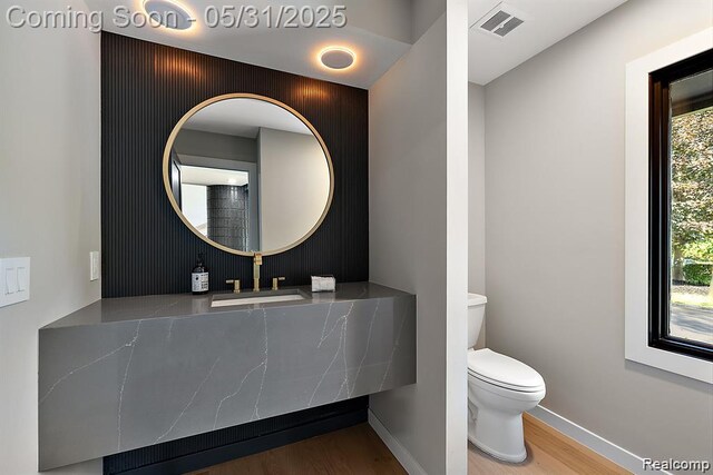 1367 W Long Lake Rd, Bloomfield Hills, MI 48302 - bathroom with wood finished floors, toilet, baseboards, and vanity