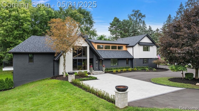 1367 W Long Lake Rd, Bloomfield Hills, MI 48302 - view of front of property with curved driveway, a front yard, brick siding, and roof with shingles