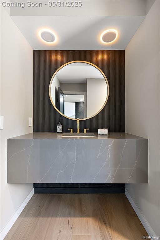 1367 W Long Lake Rd, Bloomfield Hills, MI 48302 - bathroom with a sink, wood finished floors, and baseboards