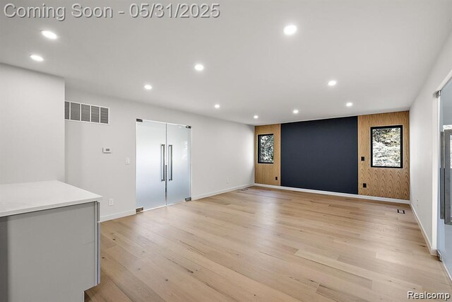 1367 W Long Lake Rd, Bloomfield Hills, MI 48302 - spare room with recessed lighting, baseboards, light wood finished floors, and an accent wall
