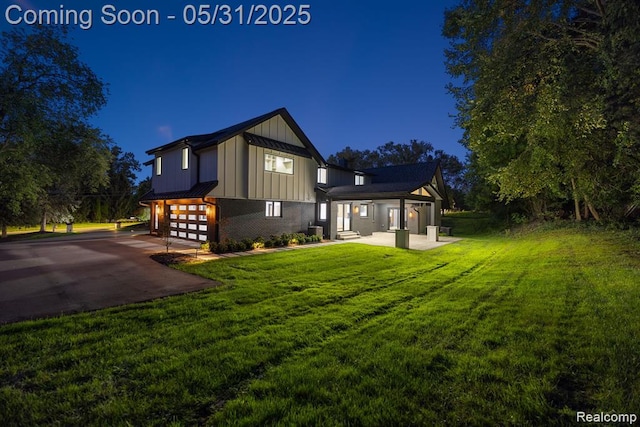 1367 W Long Lake Rd, Bloomfield Hills, MI 48302 - back of house featuring board and batten siding, a garage, a lawn, and driveway