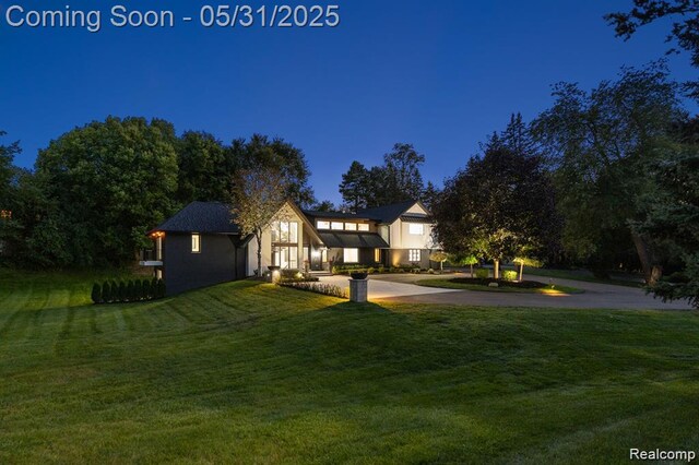 1367 W Long Lake Rd, Bloomfield Hills, MI 48302 - view of front of house featuring a front lawn, driveway, and stucco siding
