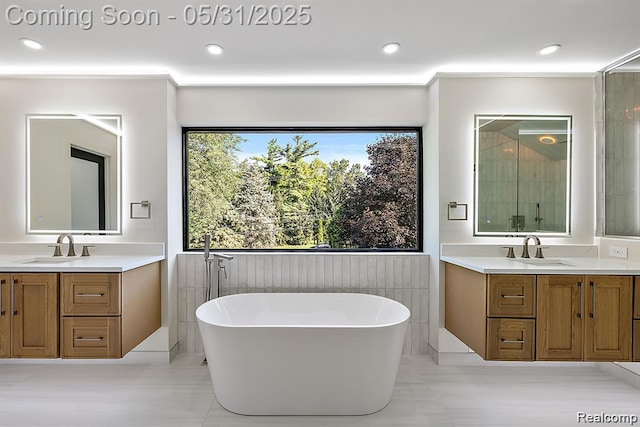1367 W Long Lake Rd, Bloomfield Hills, MI 48302 - full bath featuring a freestanding tub, two vanities, recessed lighting, an enclosed shower, and tile patterned floors