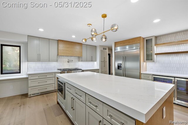 1367 W Long Lake Rd, Bloomfield Hills, MI 48302 - kitchen featuring stainless steel appliances, custom range hood, a kitchen island, decorative backsplash, and light wood-type flooring