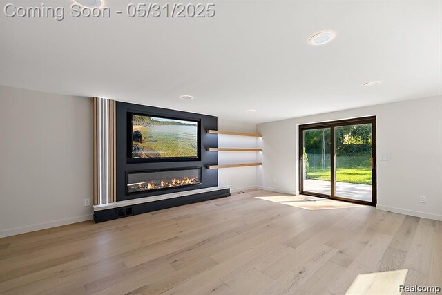 1367 W Long Lake Rd, Bloomfield Hills, MI 48302 - unfurnished living room featuring wood finished floors, a glass covered fireplace, baseboards, and recessed lighting