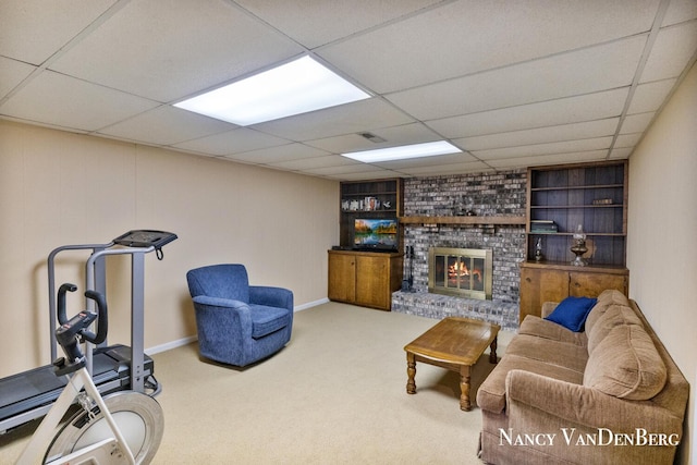 2857 Autumn Ct, Hudsonville, MI 49426 - living room featuring built in features, a fireplace, carpet floors, a paneled ceiling, and baseboards