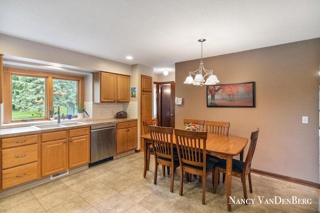 2857 Autumn Ct, Hudsonville, MI 49426 - kitchen with dishwasher, a sink, a chandelier, backsplash, and light countertops