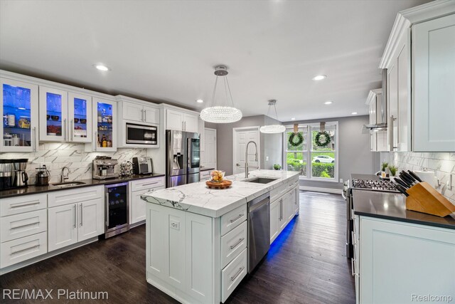 4298 Emu Dr, Pinckney, MI 48169 - kitchen with stainless steel appliances, a sink, beverage cooler, tasteful backsplash, and recessed lighting