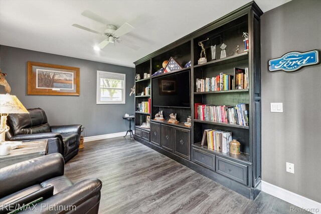 4298 Emu Dr, Pinckney, MI 48169 - sitting room featuring baseboards, wood finished floors, and a ceiling fan
