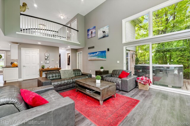 4298 Emu Dr, Pinckney, MI 48169 - living room with a high ceiling, wood finished floors, and baseboards