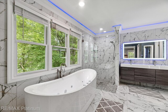 4298 Emu Dr, Pinckney, MI 48169 - full bath with tile walls, a freestanding tub, a marble finish shower, double vanity, and marble tiled floors
