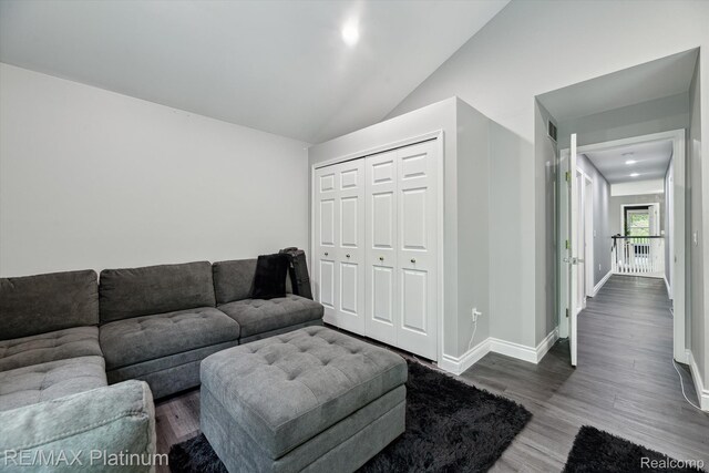 4298 Emu Dr, Pinckney, MI 48169 - living area featuring wood finished floors, lofted ceiling, and baseboards