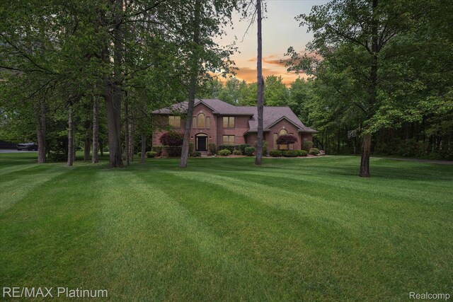 4298 Emu Dr, Pinckney, MI 48169 - view of front of house with a front yard and brick siding