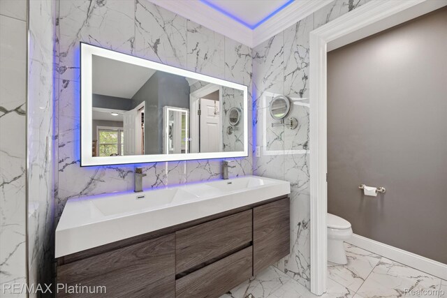 4298 Emu Dr, Pinckney, MI 48169 - bathroom featuring marble finish floors, double vanity, toilet, and tile walls
