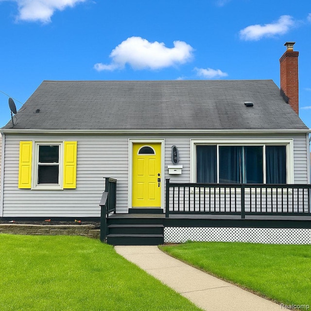 3001 Yale St, Flint, MI 48503 - view of front of home with a chimney and a front lawn