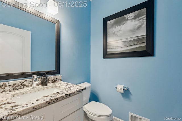 6268 Victoria Ln, Swartz Creek, MI 48473 - bathroom with toilet, baseboards, and vanity