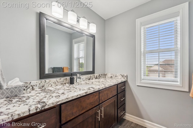 6268 Victoria Ln, Swartz Creek, MI 48473 - bathroom featuring vanity, wood finished floors, and baseboards