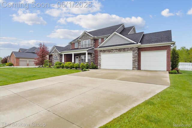 6268 Victoria Ln, Swartz Creek, MI 48473 - craftsman-style house with stone siding, an attached garage, concrete driveway, and roof with shingles