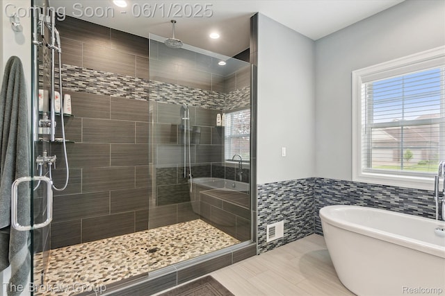 6268 Victoria Ln, Swartz Creek, MI 48473 - full bathroom with a soaking tub, a stall shower, tile walls, wainscoting, and recessed lighting