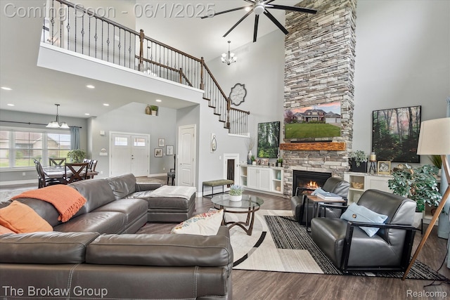 6268 Victoria Ln, Swartz Creek, MI 48473 - living area featuring a fireplace, a high ceiling, wood finished floors, ceiling fan, and a chandelier