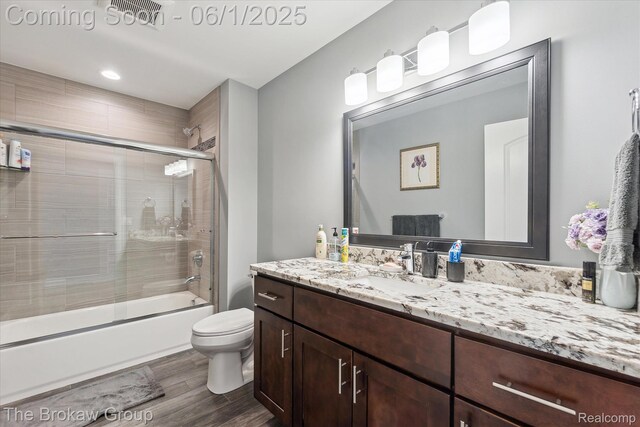 6268 Victoria Ln, Swartz Creek, MI 48473 - full bathroom with vanity, toilet, wood finished floors, and shower / bath combination with glass door