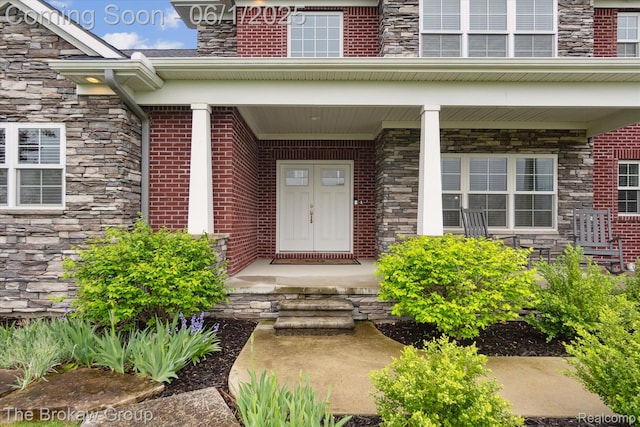 6268 Victoria Ln, Swartz Creek, MI 48473 - view of exterior entry featuring stone siding and a porch