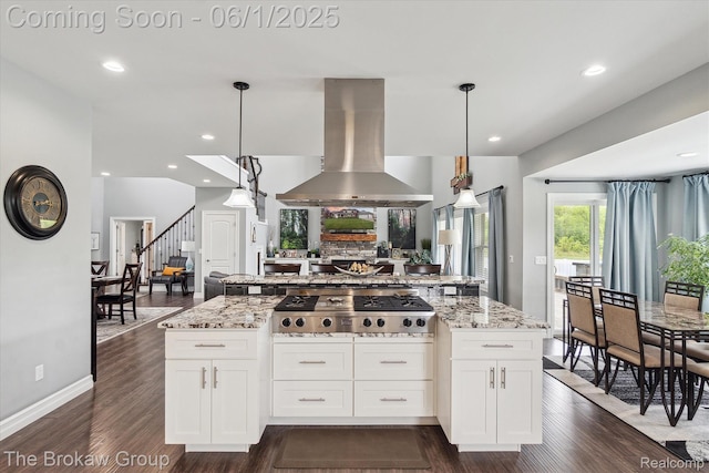 6268 Victoria Ln, Swartz Creek, MI 48473 - kitchen with stainless steel gas cooktop, island range hood, light stone countertops, dark wood-type flooring, and white cabinetry