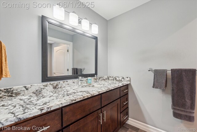 6268 Victoria Ln, Swartz Creek, MI 48473 - bathroom with vanity, wood finished floors, and baseboards