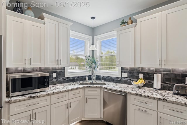 6268 Victoria Ln, Swartz Creek, MI 48473 - kitchen featuring appliances with stainless steel finishes, a sink, white cabinetry, and tasteful backsplash