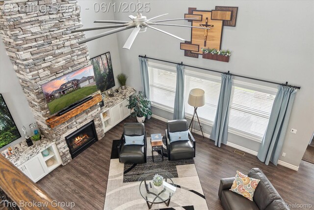 6268 Victoria Ln, Swartz Creek, MI 48473 - living room featuring ceiling fan, baseboards, a fireplace, and wood finished floors