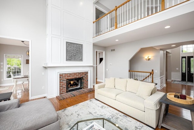 50550 W Fellows Creek Ct, Plymouth, MI 48170 - living area featuring a high ceiling, wood finished floors, a fireplace, baseboards, and recessed lighting