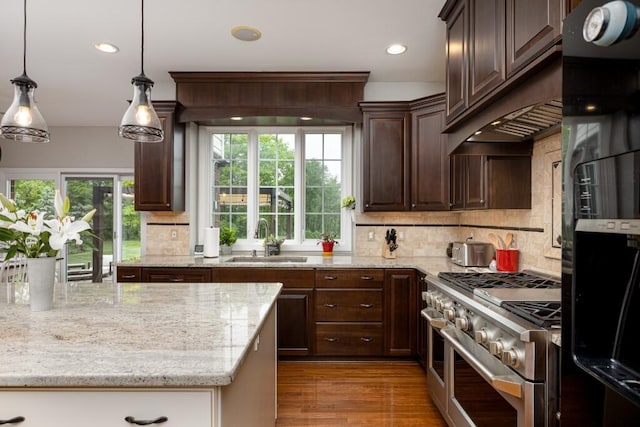 50550 W Fellows Creek Ct, Plymouth, MI 48170 - kitchen with double oven range, a sink, light stone countertops, backsplash, and dark brown cabinets
