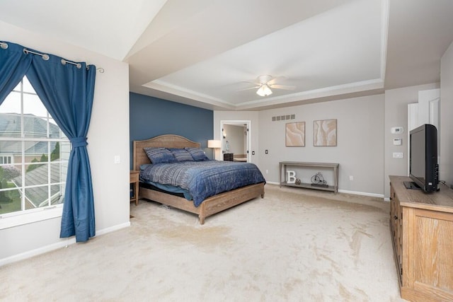 50550 W Fellows Creek Ct, Plymouth, MI 48170 - bedroom featuring a tray ceiling, baseboards, light colored carpet, and a ceiling fan