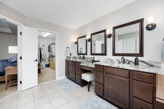 50550 W Fellows Creek Ct, Plymouth, MI 48170 - full bath with vanity, a walk in closet, tile patterned floors, ensuite bathroom, and baseboards