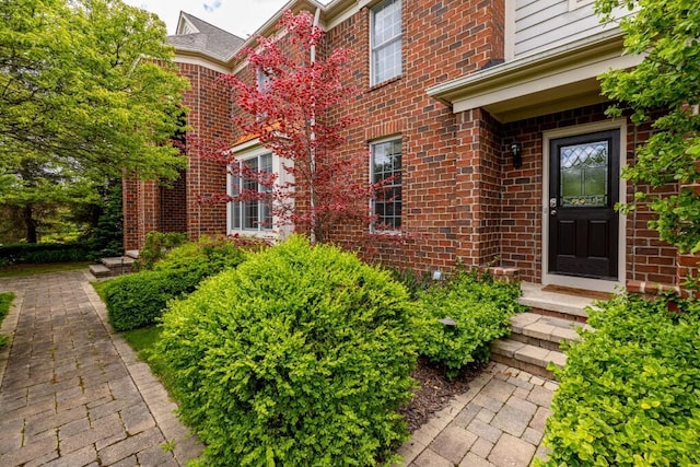 50550 W Fellows Creek Ct, Plymouth, MI 48170 - doorway to property featuring brick siding