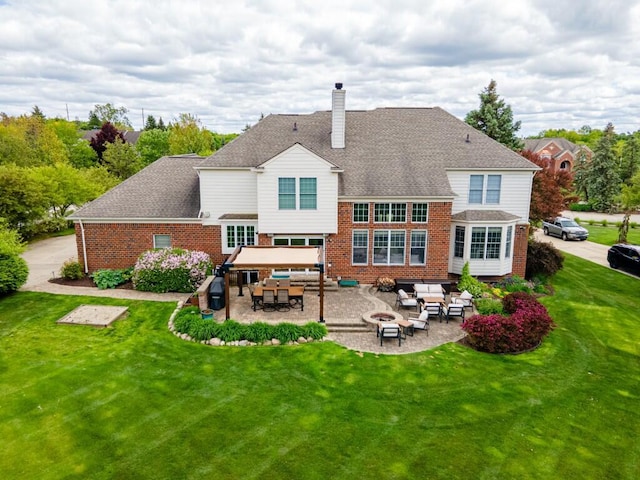 50550 W Fellows Creek Ct, Plymouth, MI 48170 - back of house with an outdoor living space with a fire pit, a chimney, a patio area, and brick siding