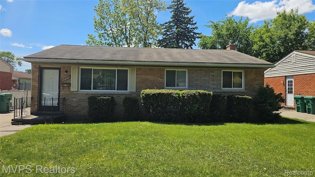 29699 Brown Ct, Garden City, MI 48135 - view of front of house featuring a front yard, a chimney, brick siding, and a shingled roof