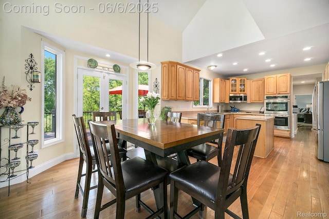 13135 Eagle Ct, South Lyon, MI 48178 - dining room with healthy amount of natural light, light wood-type flooring, baseboards, recessed lighting, and high vaulted ceiling