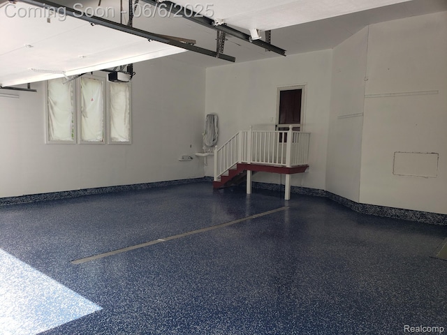 13135 Eagle Ct, South Lyon, MI 48178 - garage with baseboards and a garage door opener