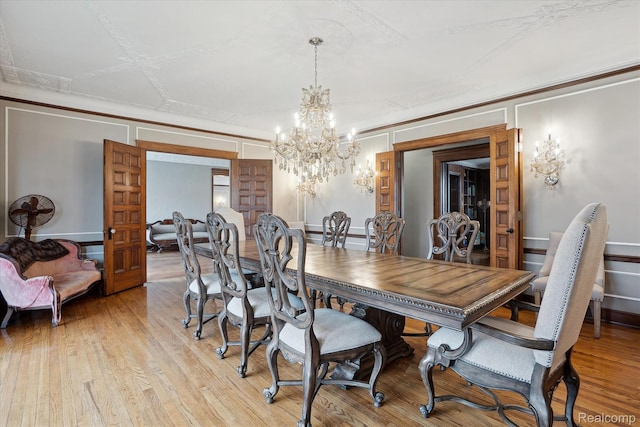 925 Avon St, Flint, MI 48503 - dining area featuring a chandelier and light wood-style floors