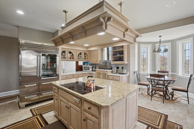 925 Avon St, Flint, MI 48503 - kitchen with stainless steel built in refrigerator, baseboards, black electric cooktop, recessed lighting, and a center island