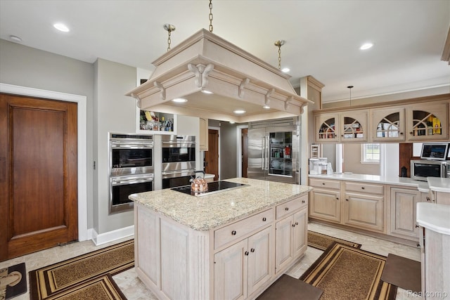 925 Avon St, Flint, MI 48503 - kitchen featuring appliances with stainless steel finishes, a center island, recessed lighting, light stone counters, and pendant lighting