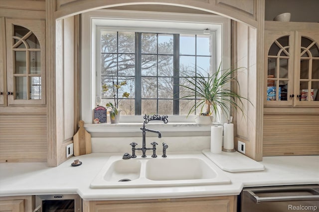 925 Avon St, Flint, MI 48503 - kitchen featuring dishwasher, a sink, glass insert cabinets, and light countertops