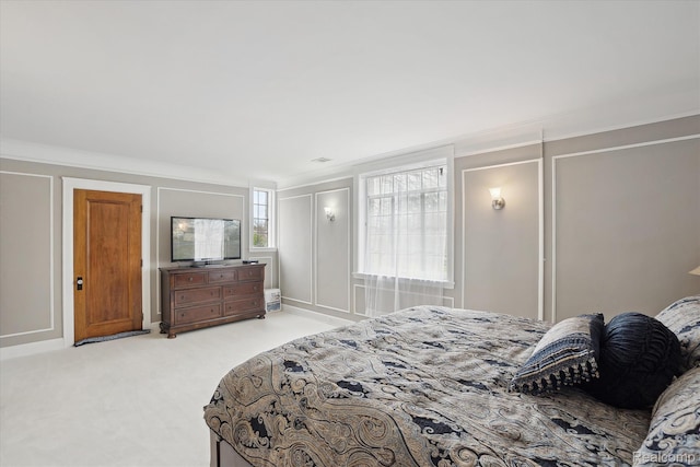 925 Avon St, Flint, MI 48503 - bedroom with crown molding, light colored carpet, and a decorative wall