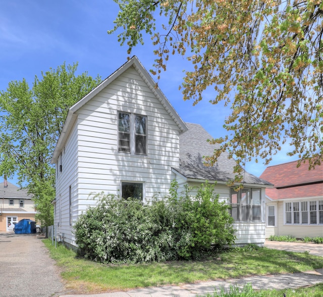 13 W 17th St, Holland, MI 49423 - view of side of property featuring a shingled roof