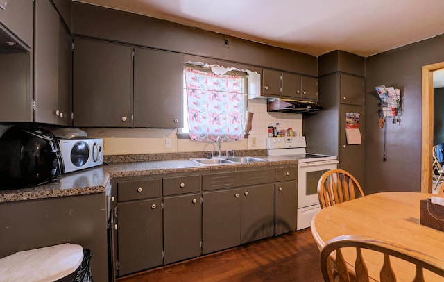 13 W 17th St, Holland, MI 49423 - kitchen with white electric range, a sink, under cabinet range hood, dark wood-style floors, and tasteful backsplash