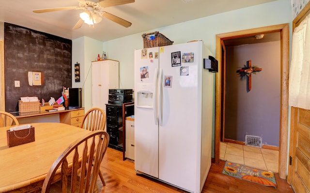13 W 17th St, Holland, MI 49423 - kitchen featuring white fridge with ice dispenser, a ceiling fan, and light wood-type flooring